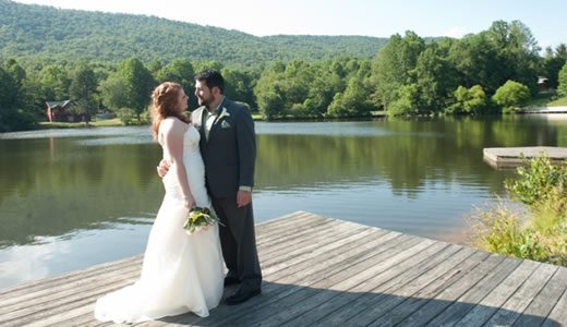 Forge Valley Event Center | Hendersonville, Brevard, Asheville | bride and groom posing for photos on the dock at the lake in the blue ridge mountains